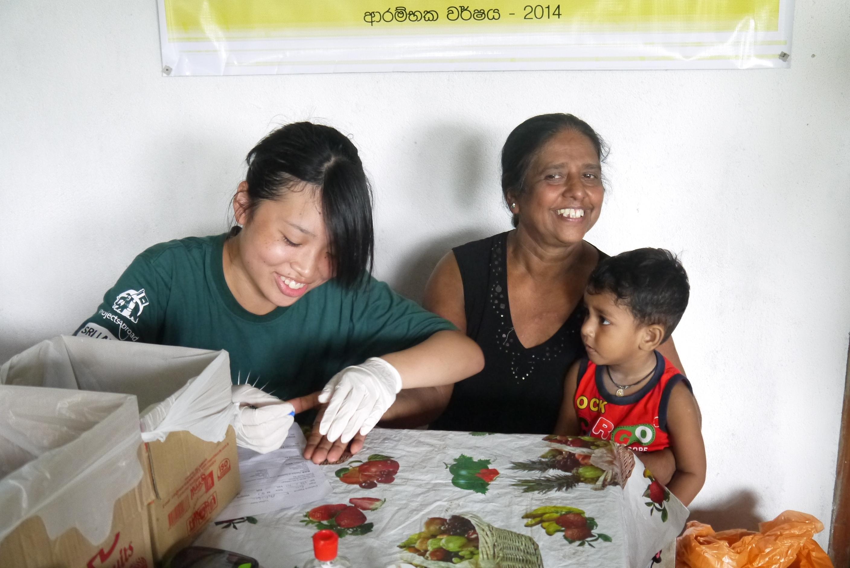 A female health care student with Projects Abroad conducting blood pressure and sugar level test as part of her nursing internship in Sri Lanka. A female health care student is seen taking blood pressure and sugar levels ina . local surgery as part of her nursing internship in Sri Lanka with Projects Abroad.